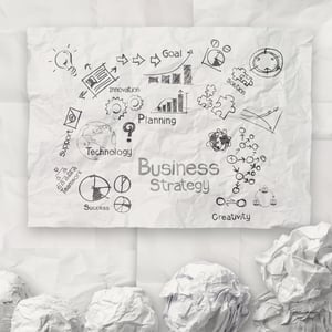 hand drawing creative business strategy on crumpled paper background as concept